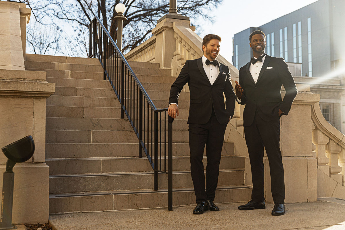 A man in a tuxedo on stone stairs