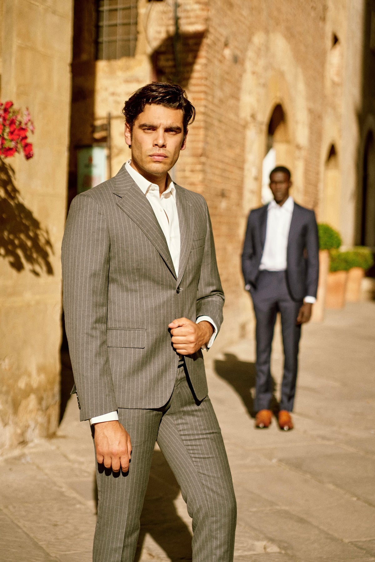 A man in a gray suit on a Tuscan street