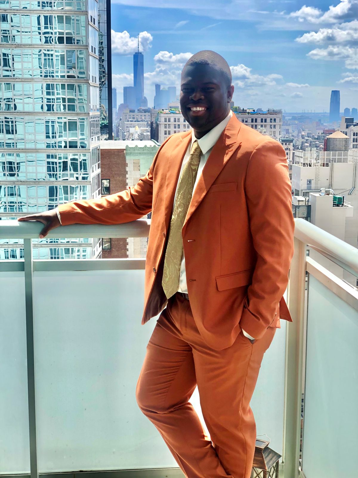 Reginald in a burnt orange suit